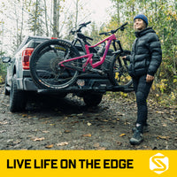 Cyclist securing a bike on the Saris Edge 2-Bike Hitch Rack