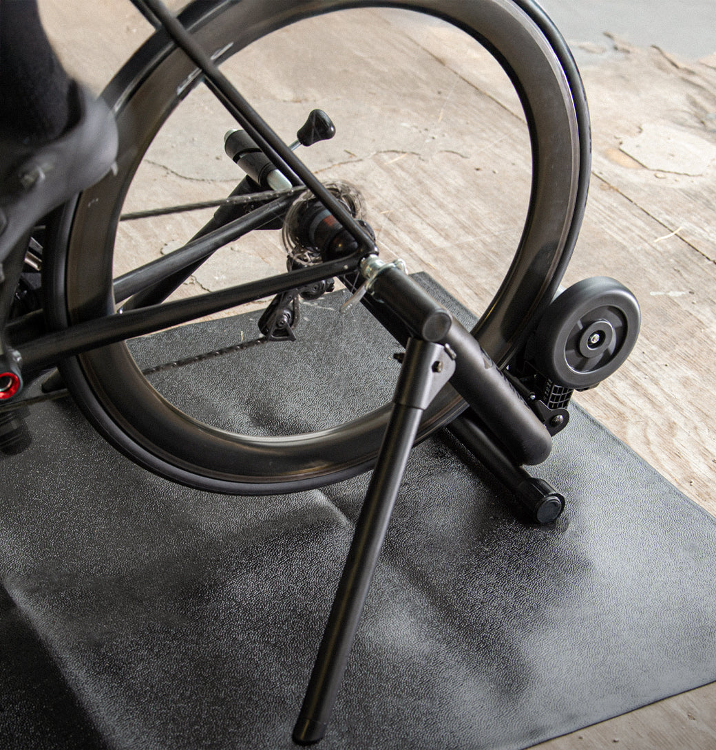 Cyclist doing a steady ride on the Saris MAG Trainer in a garage setup