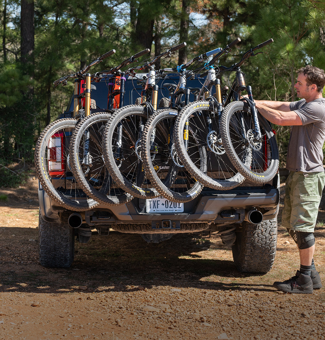 Three mountain bikes secured on the Saris Tailgate Pad — truck tailgate fully loaded
