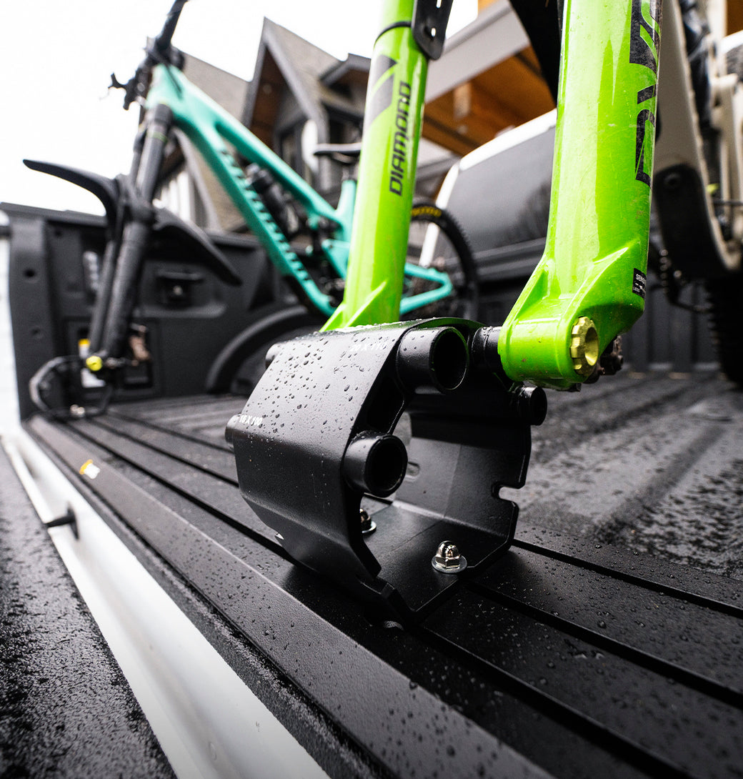 Two mountain bikes loaded in Saris Traps carriers in truck bed — headed to trail