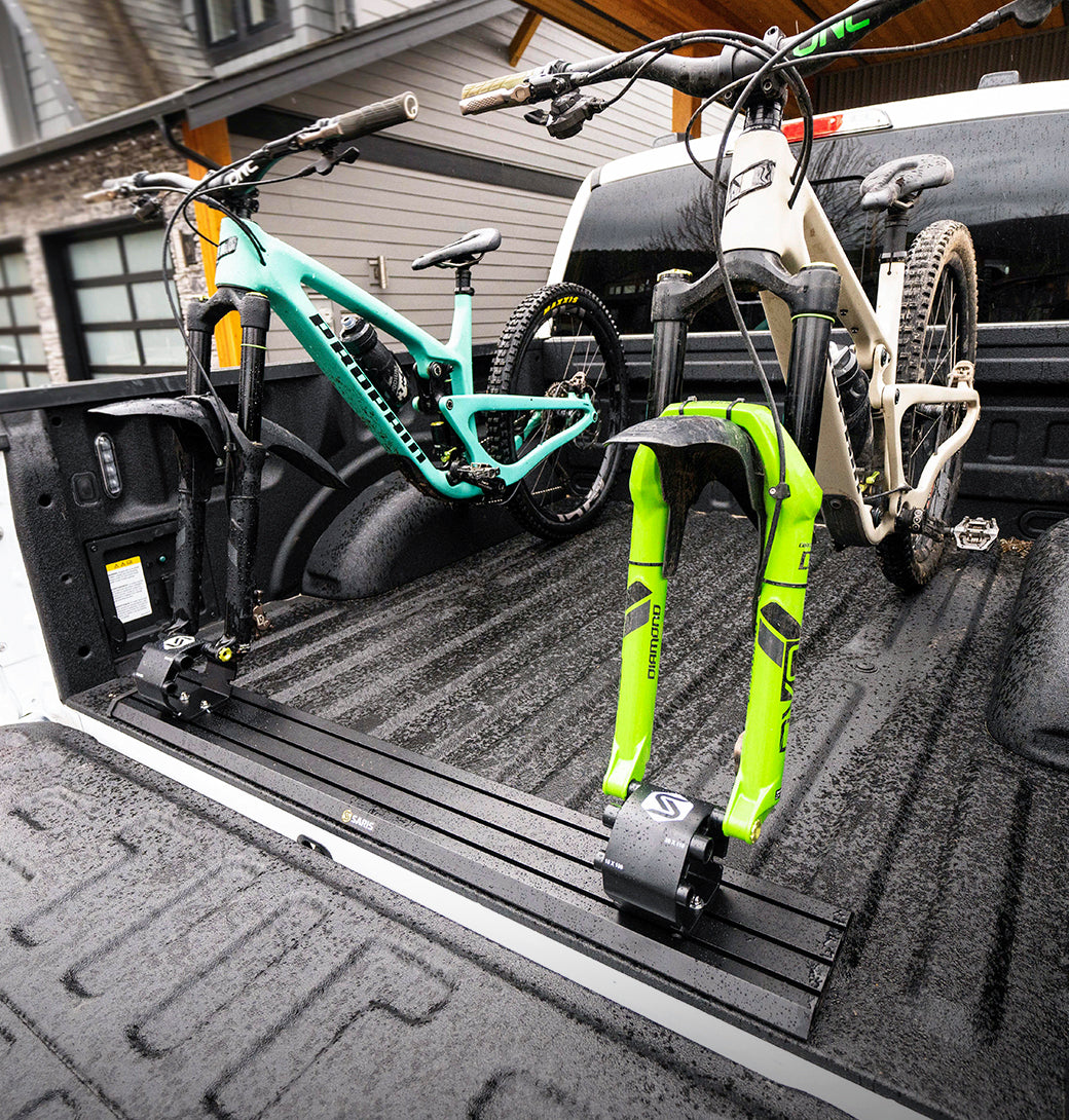 Saris Traps Triple Track (TRK33/TRK34) — three-carrier system in truck bed, empty