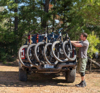Loading a sixth bike onto the Saris Tailgate Pad — maximum bike capacity