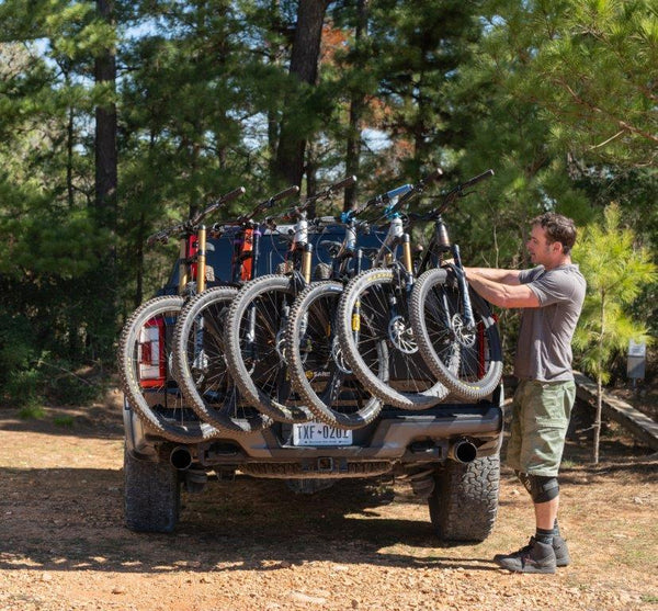 Loading a sixth bike onto the Saris Tailgate Pad — maximum bike capacity