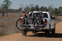 Three mountain bikes secured on the Saris Tailgate Pad — truck tailgate loaded