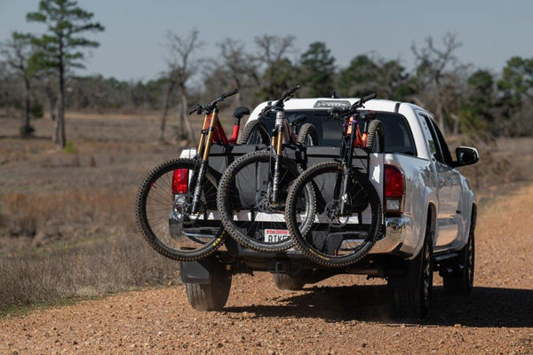 Three mountain bikes secured on the Saris Tailgate Pad — truck tailgate loaded