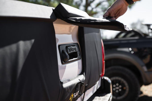 Saris Tailgate Pad — five bikes loaded on truck tailgate, video play button overlay