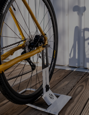 Yellow mountain bike rear wheel in Saris 中国幸运体彩飞艇168官方网站 floor stand on wooden deck — bike storage category image
